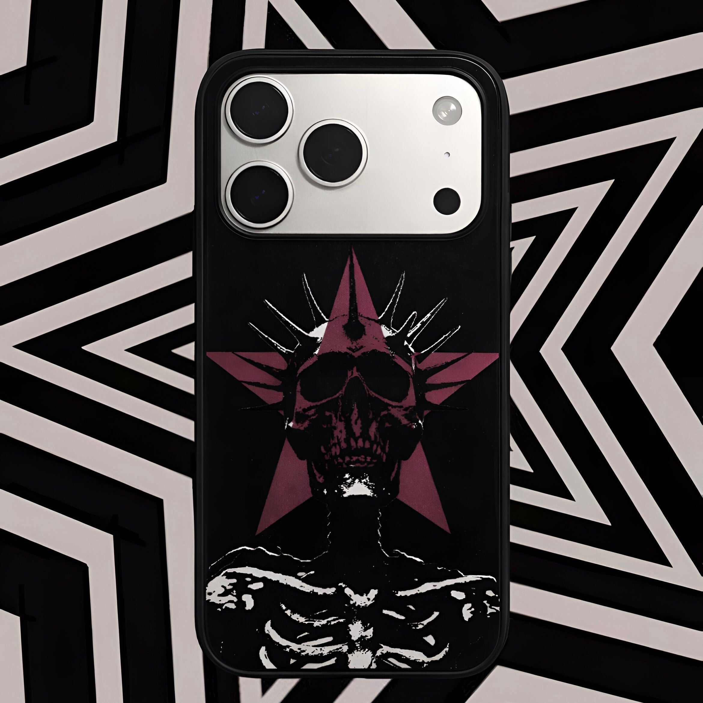 Phone case with a black and red design on a geometric patterned background