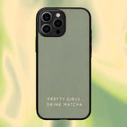 Phone case with 'Pretty Girls Drink Matcha' text on a blurred green background